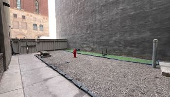 a red fire hydrant on a sidewalk next to a building at The Commonwealth Building, Pittsburgh, 15222